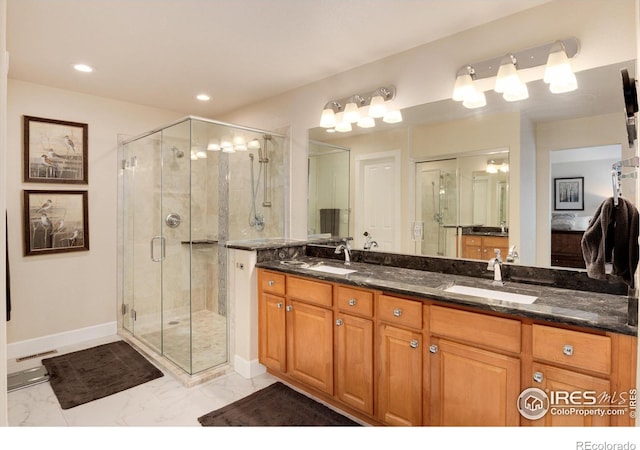 bathroom with a shower with door and vanity