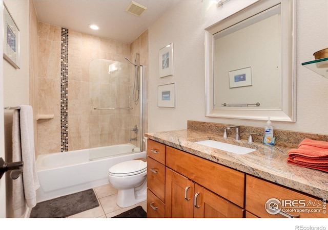 full bathroom with tiled shower / bath, vanity, toilet, and tile patterned flooring