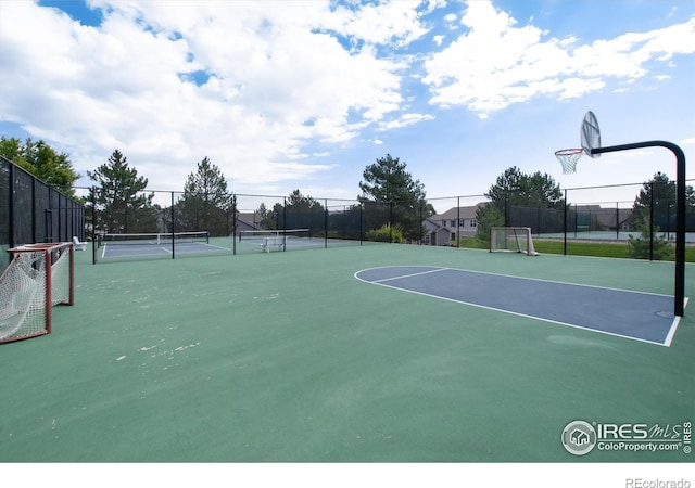 view of basketball court featuring tennis court