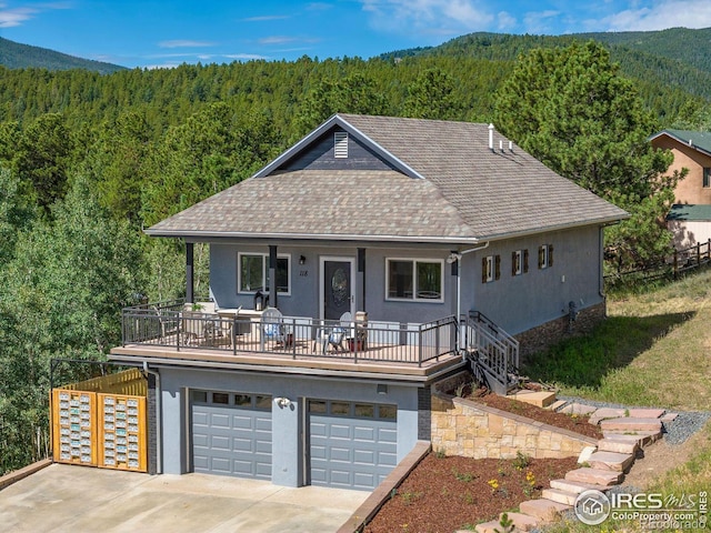 view of front of house with a garage and a mountain view