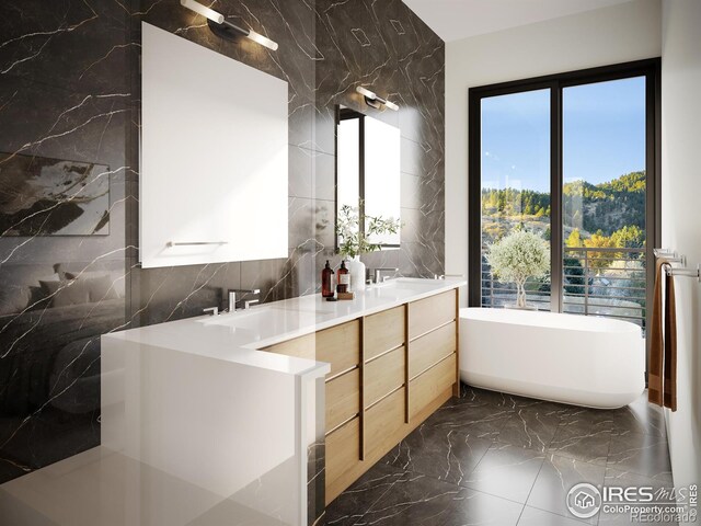 bathroom with vanity, a bathing tub, and tile walls