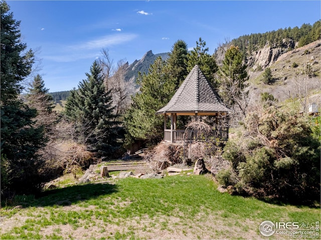 view of yard with a mountain view and a gazebo