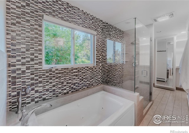 bathroom with separate shower and tub and tile patterned flooring