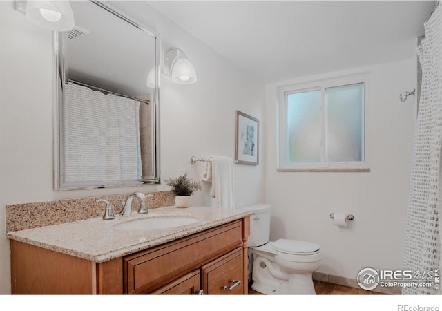 bathroom with vanity and toilet