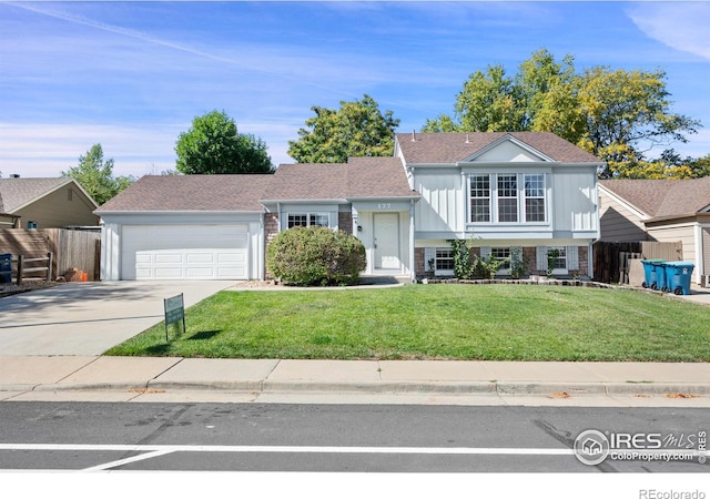 tri-level home with a front yard and a garage