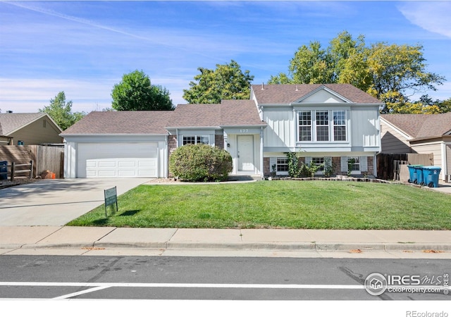 177 S Polk Ave, Louisville, CO 80027 - split level home with a garage, board and batten siding, fence, a front lawn, and driveway