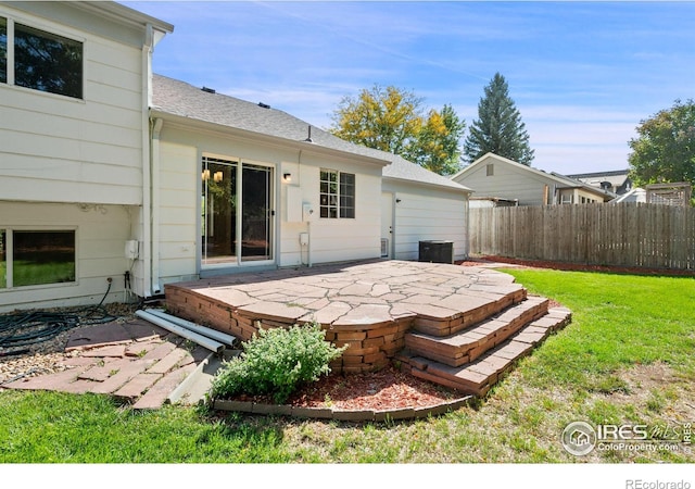 rear view of property featuring a lawn and a patio