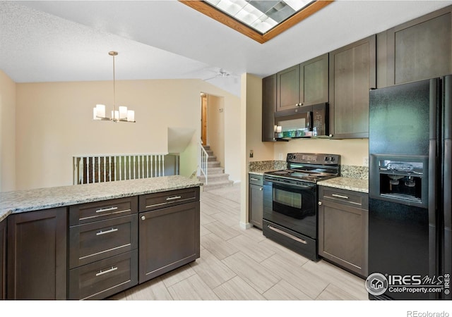 kitchen with dark brown cabinets, light stone counters, lofted ceiling, hanging light fixtures, and black appliances