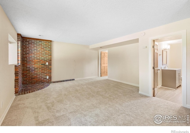 177 S Polk Ave, Louisville, CO 80027 - unfurnished living room with a textured ceiling, baseboards, and carpet