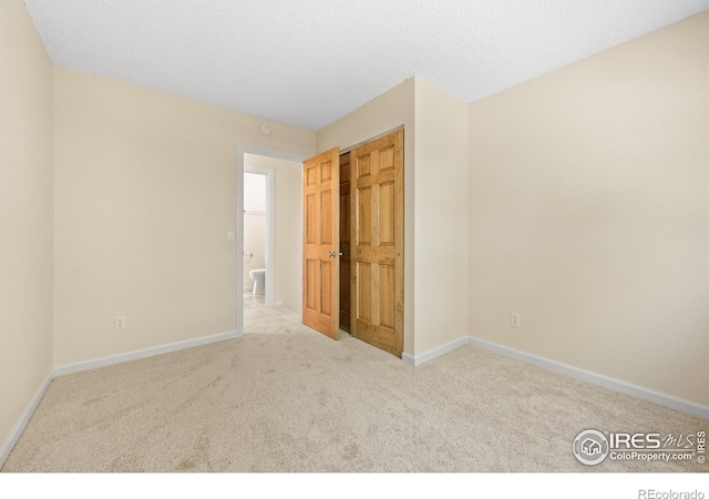 carpeted spare room with a textured ceiling