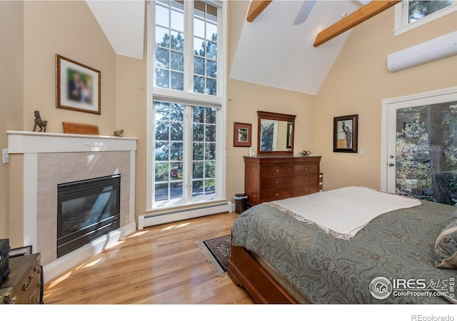 bedroom featuring high vaulted ceiling, a fireplace, access to outside, baseboard heating, and light hardwood / wood-style flooring