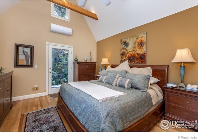 bedroom featuring beam ceiling, high vaulted ceiling, access to outside, an AC wall unit, and light wood-type flooring