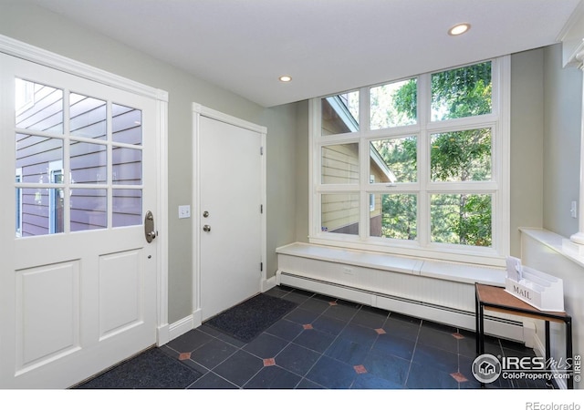 tiled entrance foyer with a baseboard heating unit