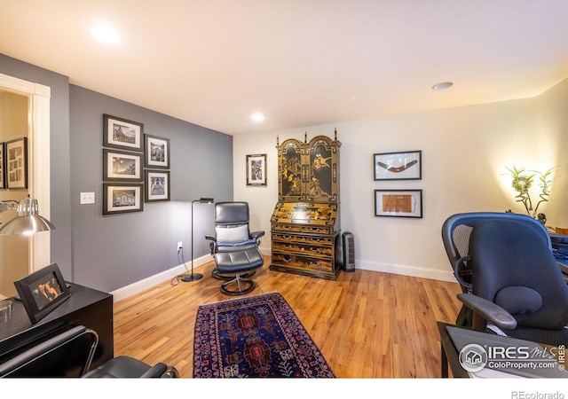 home office with light hardwood / wood-style floors