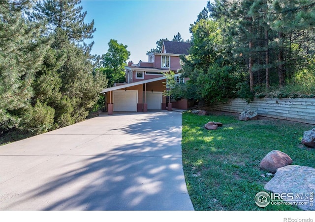 view of front of house with a front yard and a carport