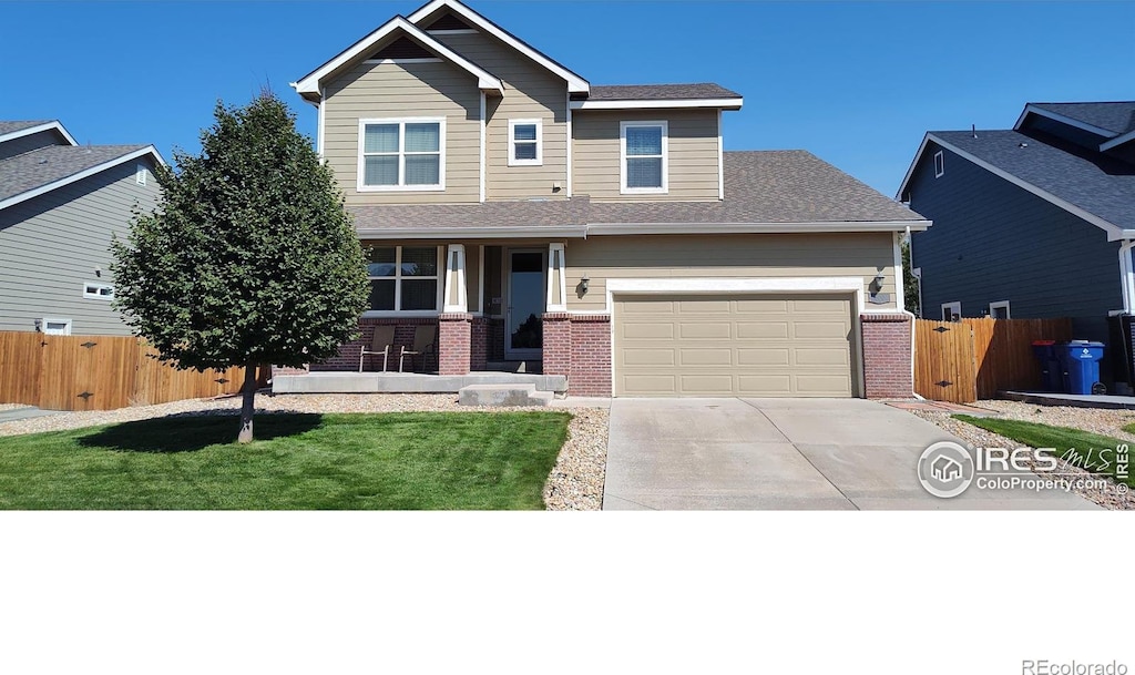 craftsman house featuring a garage and a front lawn