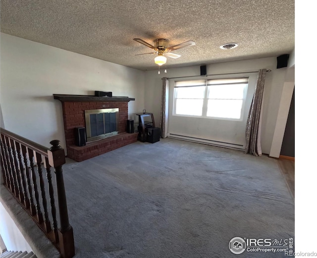 unfurnished living room with a baseboard heating unit, a textured ceiling, carpet floors, and a brick fireplace