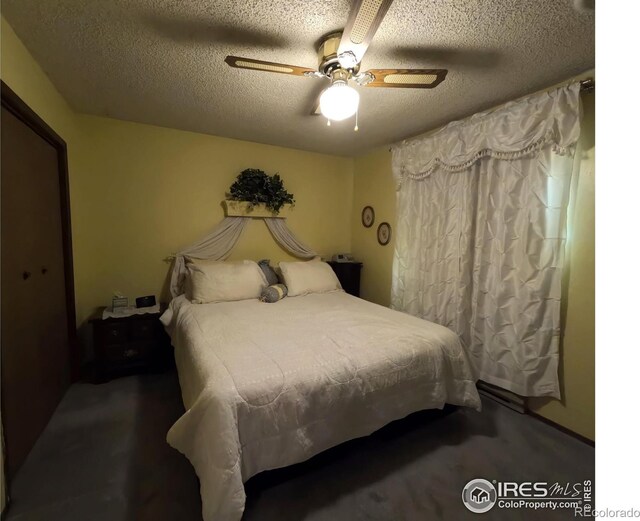 bedroom with ceiling fan and a textured ceiling