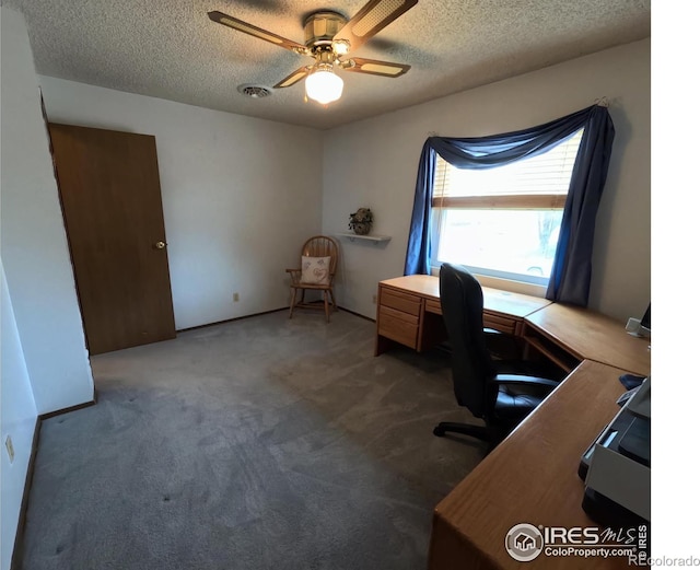 unfurnished office featuring ceiling fan, carpet floors, and a textured ceiling