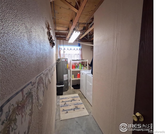 basement featuring electric water heater and independent washer and dryer