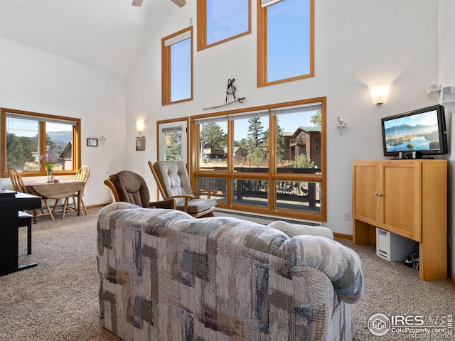 carpeted living room with high vaulted ceiling and ceiling fan