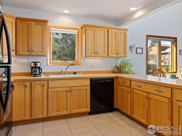 kitchen with black appliances, light tile patterned flooring, and sink