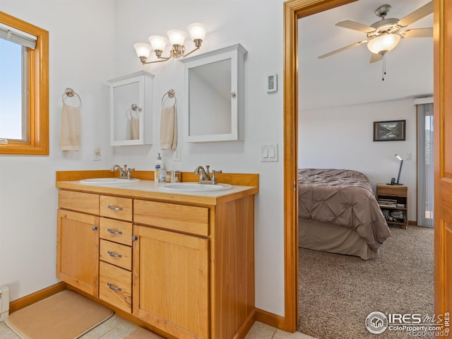 bathroom with ceiling fan, double vanity, a sink, and connected bathroom