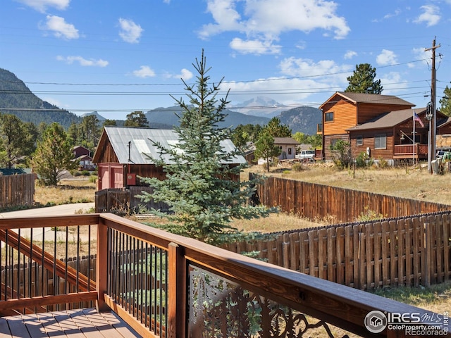 deck with an outbuilding and a mountain view