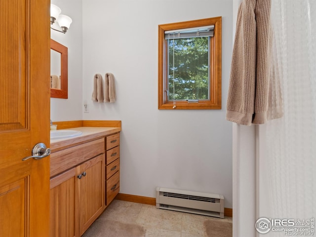 bathroom with tile patterned flooring, baseboards, baseboard heating, and vanity