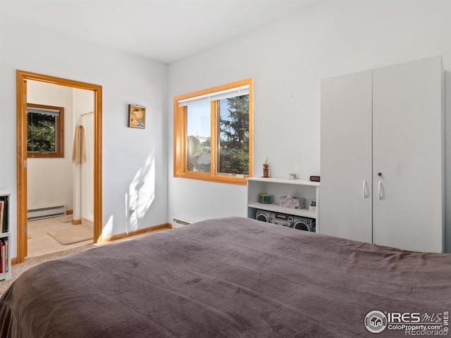 unfurnished bedroom featuring a baseboard heating unit, light carpet, and ensuite bathroom