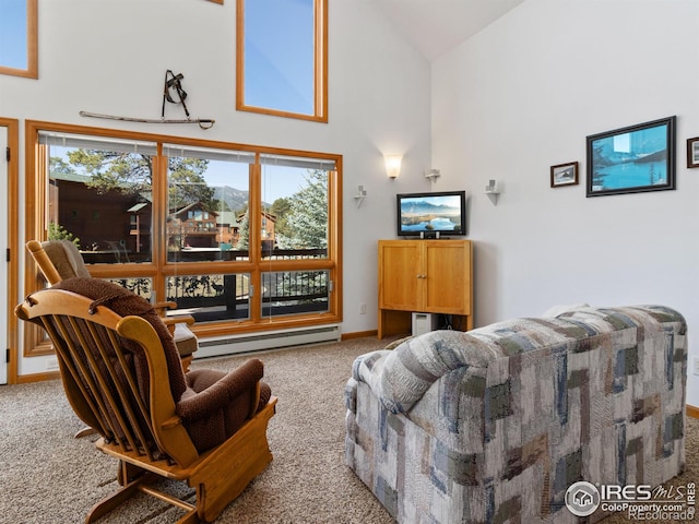 living room with high vaulted ceiling, baseboard heating, and carpet floors