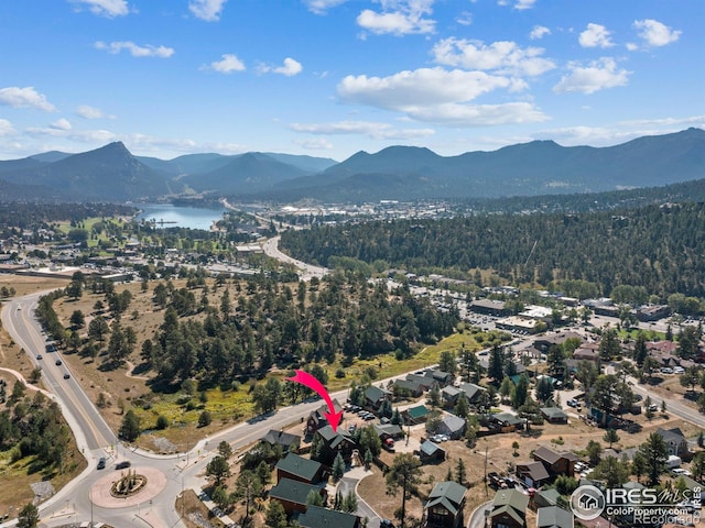 drone / aerial view with a water and mountain view