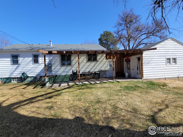 rear view of property featuring a yard and a patio