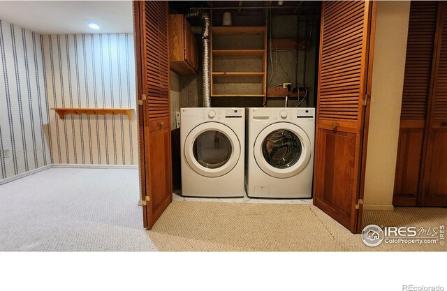 washroom with washing machine and dryer and light carpet