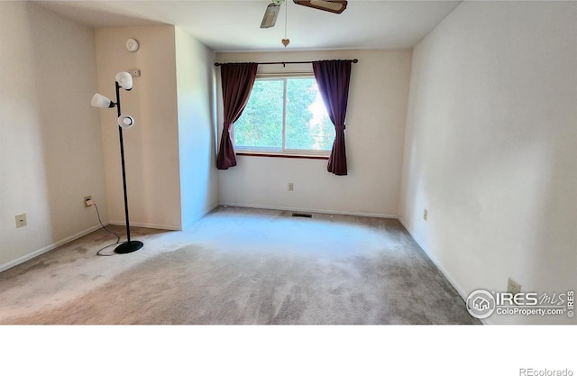 carpeted empty room featuring ceiling fan