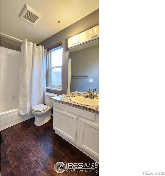 full bathroom with shower / bath combination with curtain, vanity, wood-type flooring, and toilet