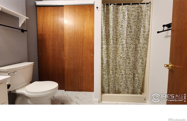 bathroom with a shower with curtain and toilet