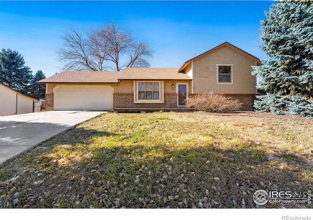 view of front of home with a front yard and a garage