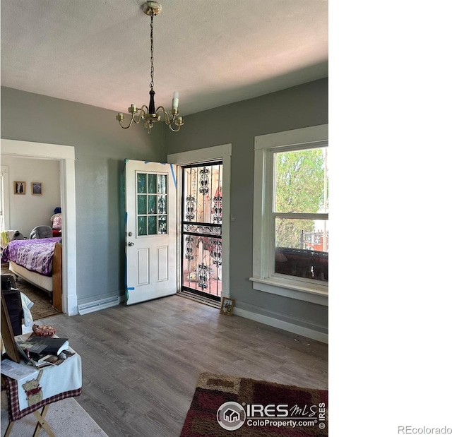 interior space with hardwood / wood-style floors and an inviting chandelier