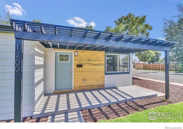 view of exterior entry with a carport