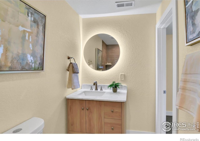 bathroom with vanity and toilet