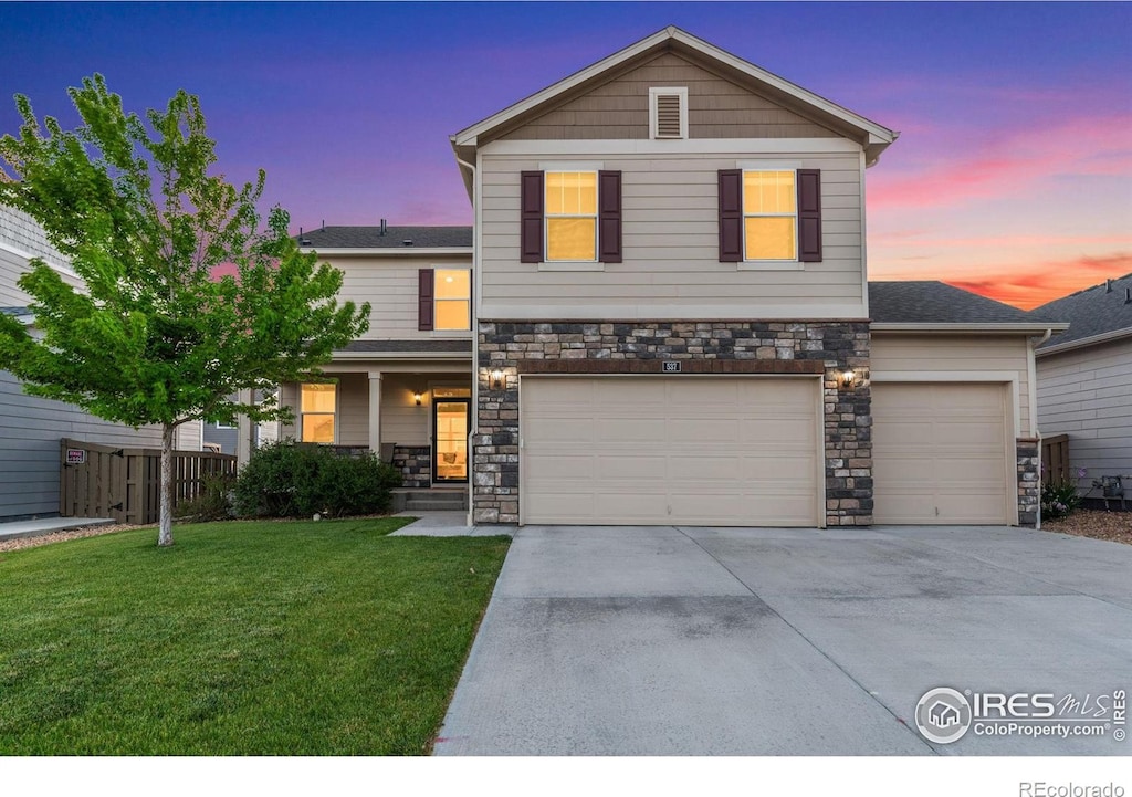 front of property featuring a garage and a yard