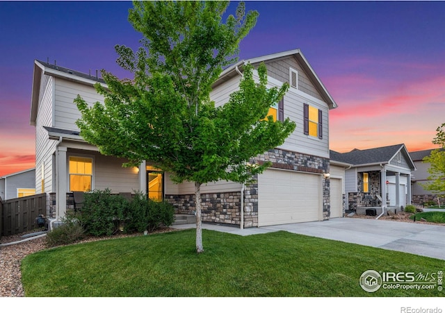 view of front of property featuring a lawn and a garage