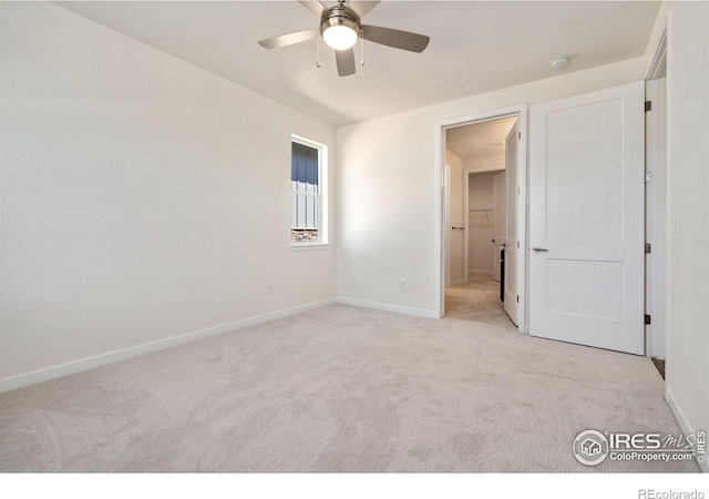 unfurnished bedroom featuring light carpet, ceiling fan, and baseboards