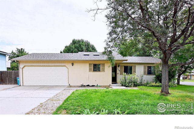 ranch-style home with a front lawn and a garage