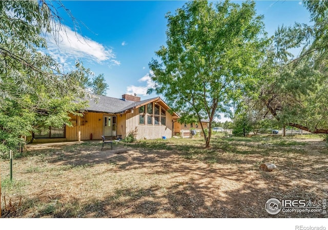 back of house with a sunroom