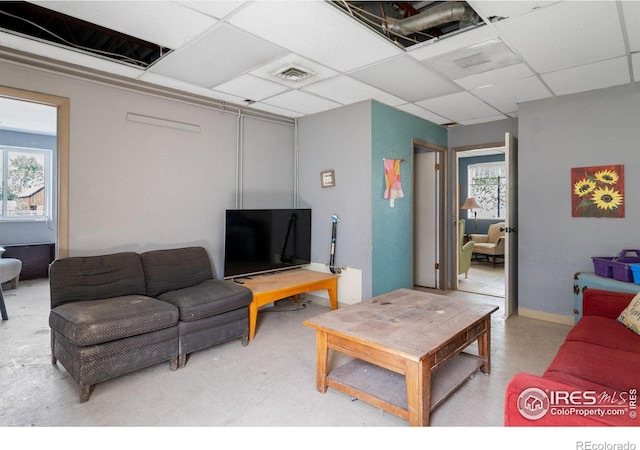 living room with a drop ceiling