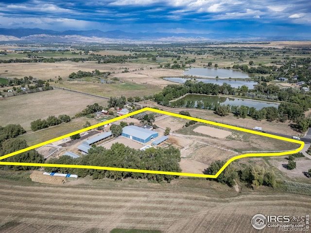 birds eye view of property featuring a water and mountain view