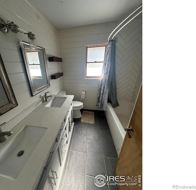 full bathroom with toilet, wood walls, and shower / tub combo