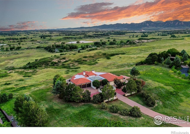 aerial view at dusk featuring a mountain view